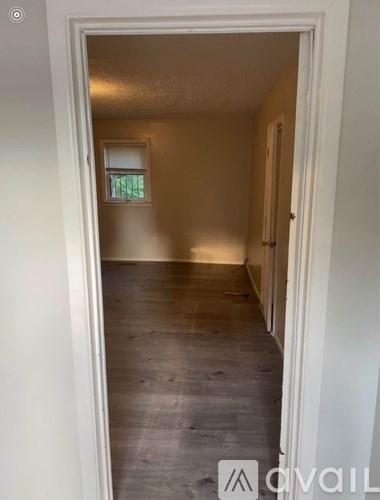 A hallway with a doorway leading to another room.