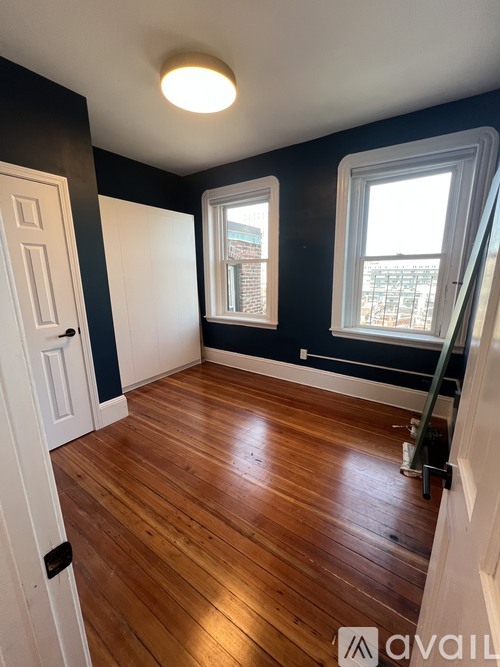 A room with wooden floors and white doors.