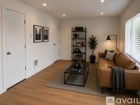 A living room with a brown leather couch and a coffee table.
