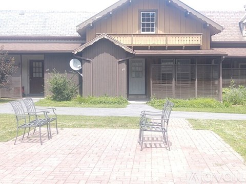 A house with a brown roof and a grey door.