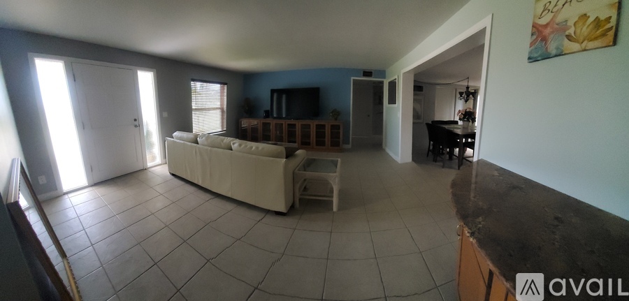 A living room with a couch and a television.