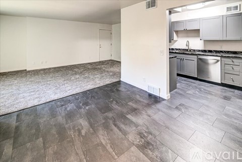A kitchen area with a counter and cabinets.