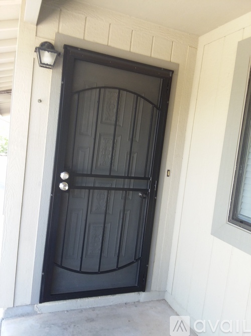 A black door with a white frame and a window to the right.