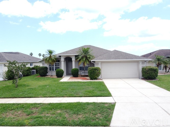 A house with a white garage door and a red brick walkway.