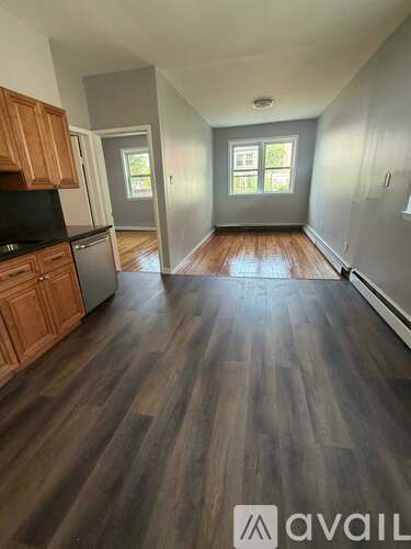 A kitchen with wooden cabinets and a black countertop.