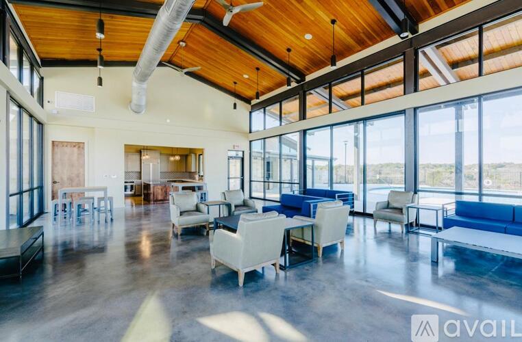 A spacious room with a high ceiling and large windows.