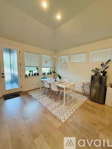 A kitchen with a table and chairs in the middle of the room.