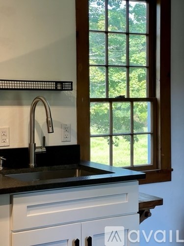 A kitchen with a sink and a window.