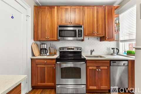 A kitchen with wooden cabinets and stainless steel appliances.