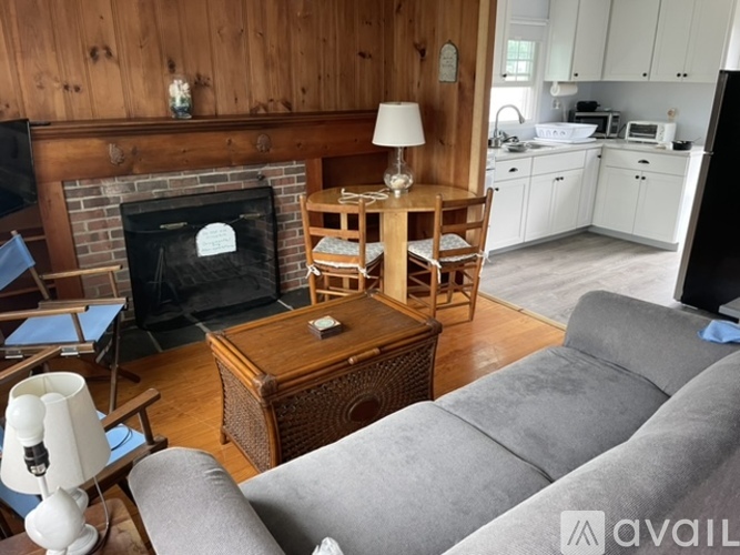 A living room with a grey couch and a wooden coffee table.