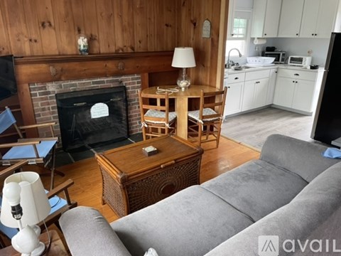 A living room with a grey couch and a wooden coffee table.