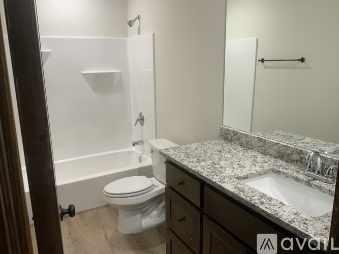 A bathroom with a toilet, sink, and bathtub.