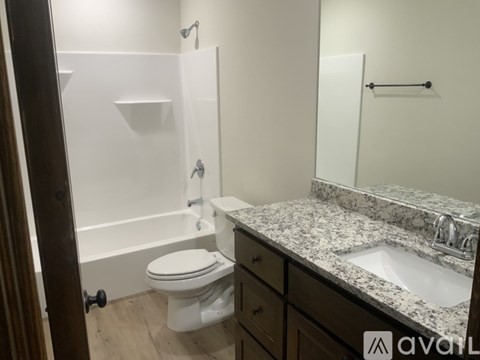 A bathroom with a toilet, sink, and bathtub.