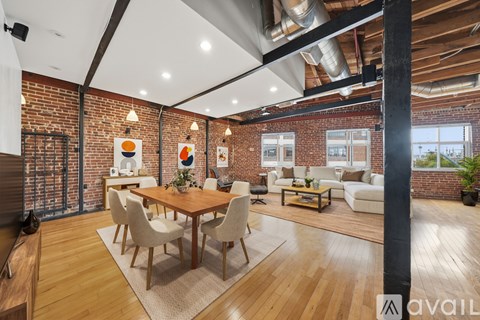 A modern living room with a wooden dining table and chairs.