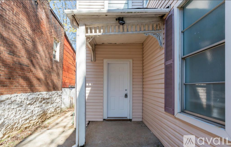 A small house with a white door and a window.