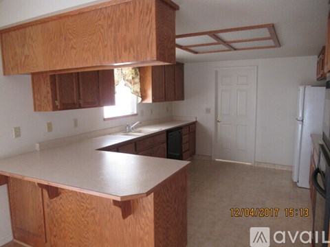A kitchen with wooden cabinets and a countertop.