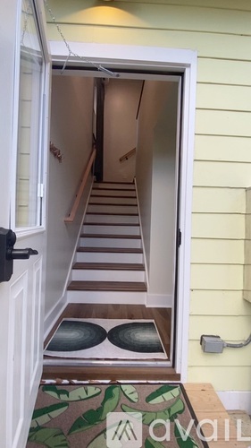 A hallway with a staircase leading to the second floor.