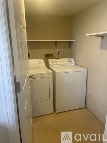 A small laundry room with two washing machines.