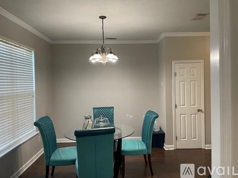 A dining room with a glass table and chairs.