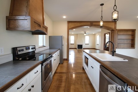 A kitchen with wooden cabinets and a black stove top oven.