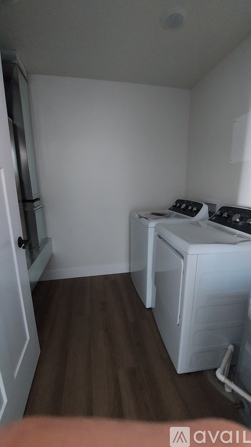 A small laundry room with a washer and dryer.