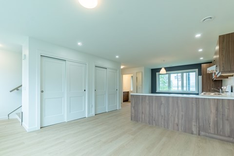 A spacious kitchen with a bar counter and a staircase.