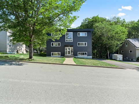 A modern two-story house with a flat roof and large windows.