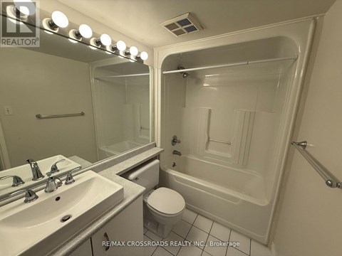 A bathroom with a sink, toilet, and bathtub.