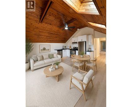 A living room with a couch, chairs, and a coffee table.