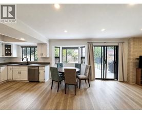 A modern kitchen with a dining table set up.