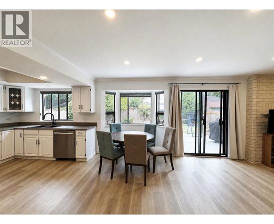 A modern kitchen with a dining table set up.