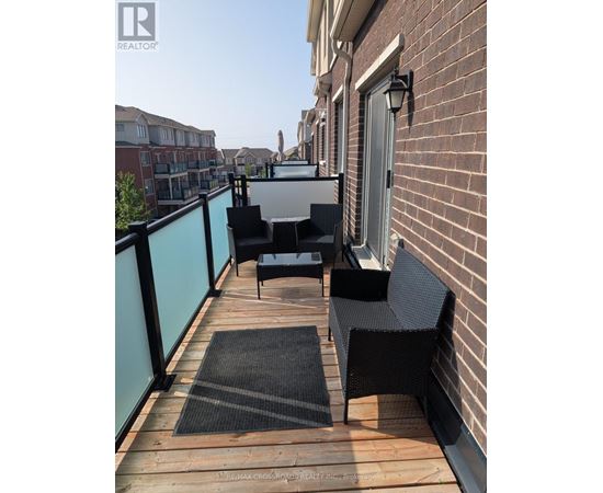 A balcony with a table and chairs.