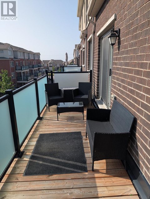A balcony with a table and chairs.