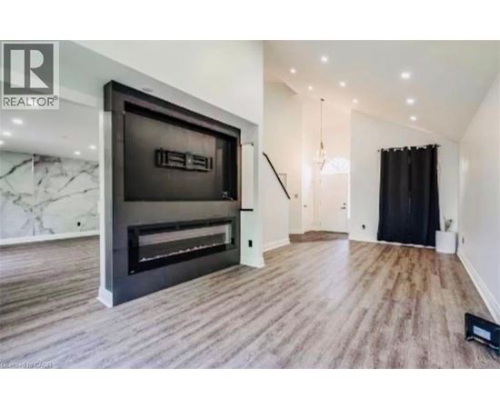 A modern living room with a fireplace and a flat screen TV.