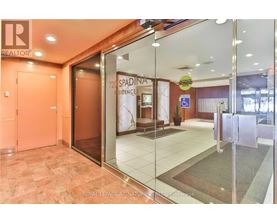 The image shows the entrance to a Spadina residences building with a glass door and a Royal LePage sign.