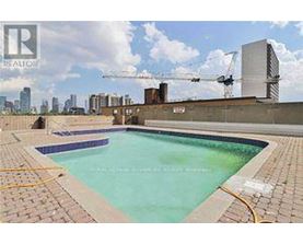 A swimming pool with a construction site in the background.