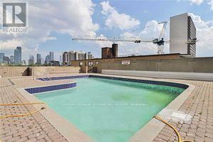 A swimming pool with a construction site in the background.