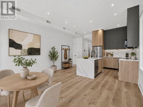 A modern kitchen with a dining table and chairs.
