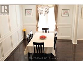 A dining room with a table set for four.