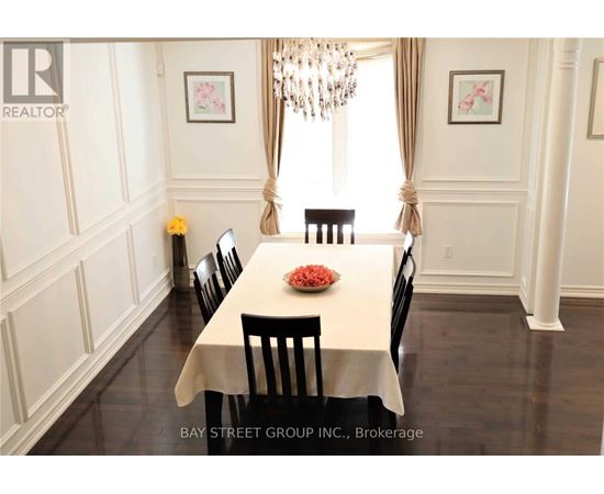 A dining room with a table set for four.