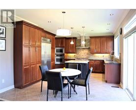 A kitchen with a table and chairs in the middle of it.