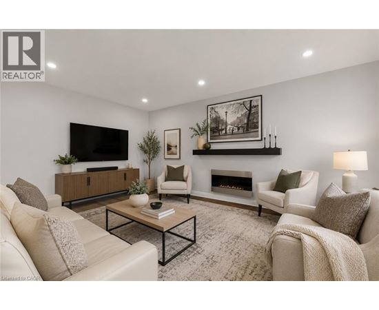 A living room with a fireplace, a television, and a coffee table.
