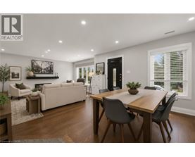 A well-lit, modern dining room with a wooden table and chairs.