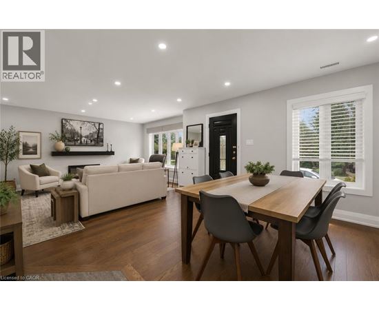 A well-lit, modern dining room with a wooden table and chairs.