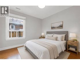 A bedroom with a large bed and a window.