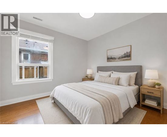 A bedroom with a large bed and a window.