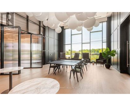 A modern dining room with a long table and chairs.