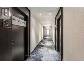 A hallway with a sign that says "Welcome Home" on the door.
