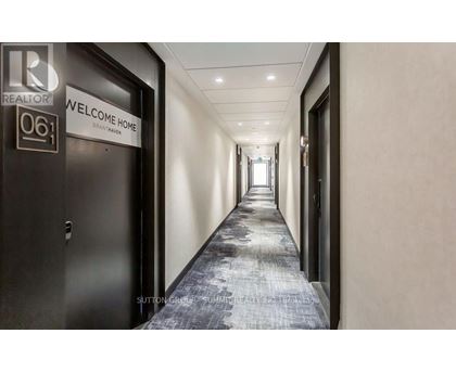 A hallway with a sign that says "Welcome Home" on the door.