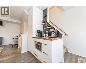 A modern kitchen with a white cabinet and a wooden countertop.